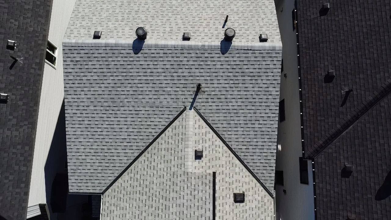 Drone aerial photo showing roof shingles and flashing from above
