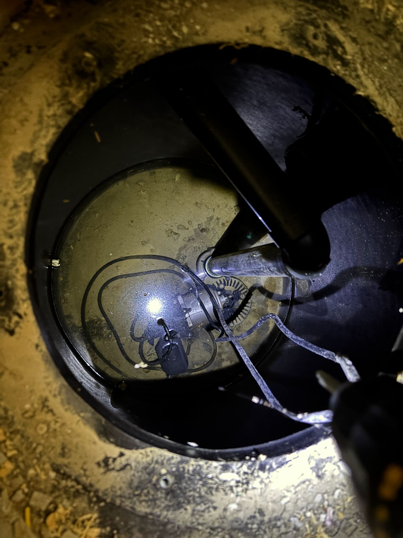 Underground sump pump and plumbing components inside a cistern