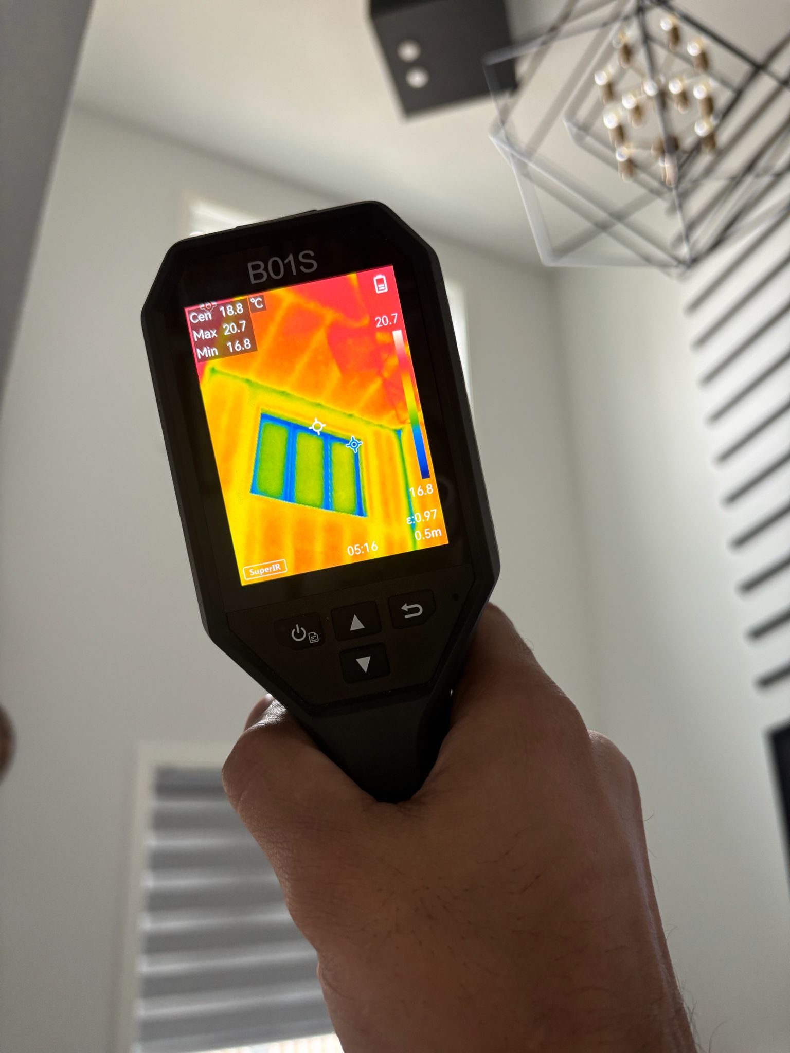Thermal imaging camera scanning walls during a home inspection